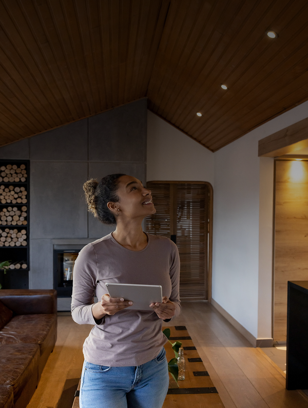 Woman holding tablet in modern living room