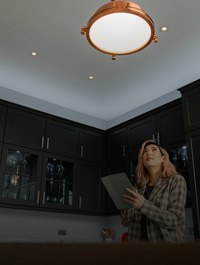 Individual checking overhead light in kitchen