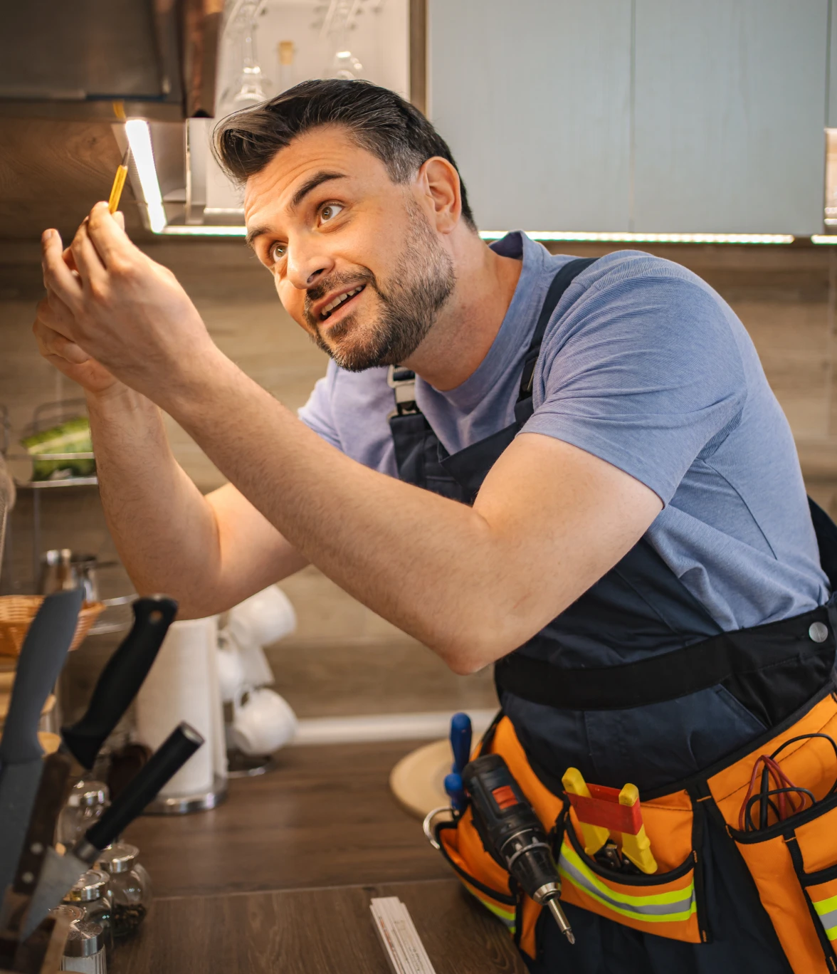 Technician repairing kitchen lighting