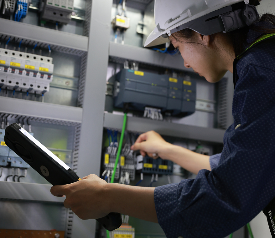 Electrician examining control panel components
